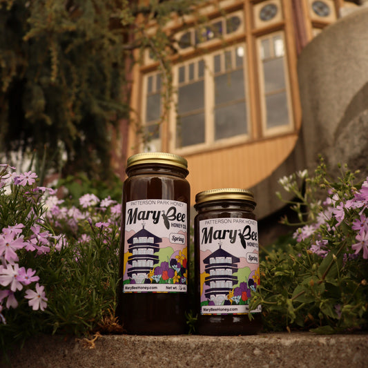 Two jars of dark honey sit in front of the Patterson Park Observatory in Baltimore.